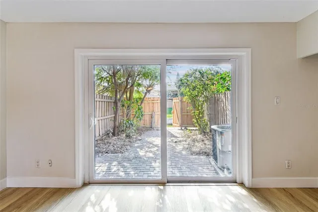 a view of a room with wooden floor and a window