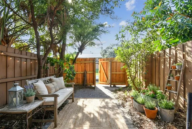 a view of backyard with outdoor seating and plants