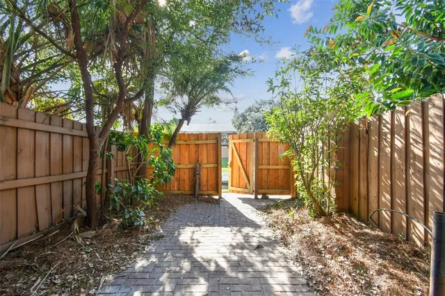 a view of a house with backyard and trees