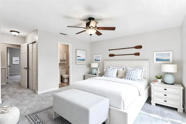a bedroom with a white bed and a chandelier