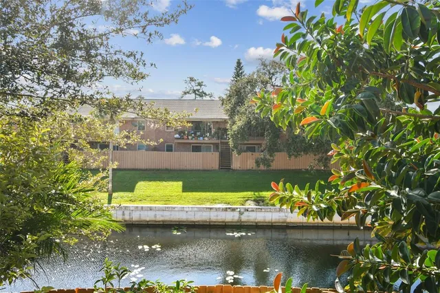 a view of swimming pool with a yard and plants
