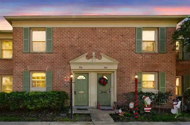 a view of a house with many windows and yard