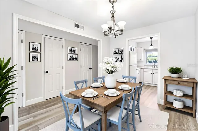 a view of a dining room with furniture wooden floor and a chandelier