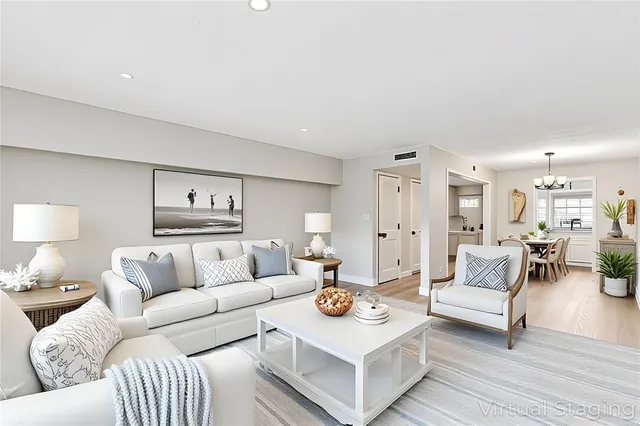 a living room with furniture and view of kitchen