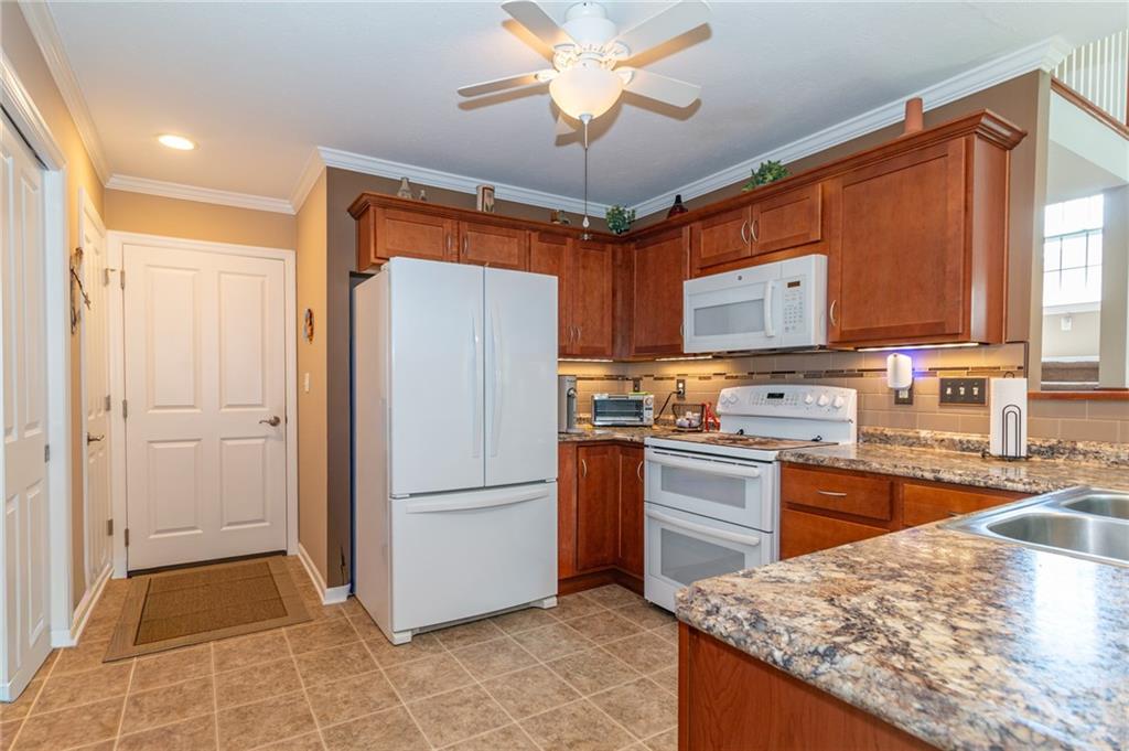 425 Chestnut Lane Apollo, PA 15613 - Photo 9 of 48 a kitchen with granite countertop a refrigerator and a sink