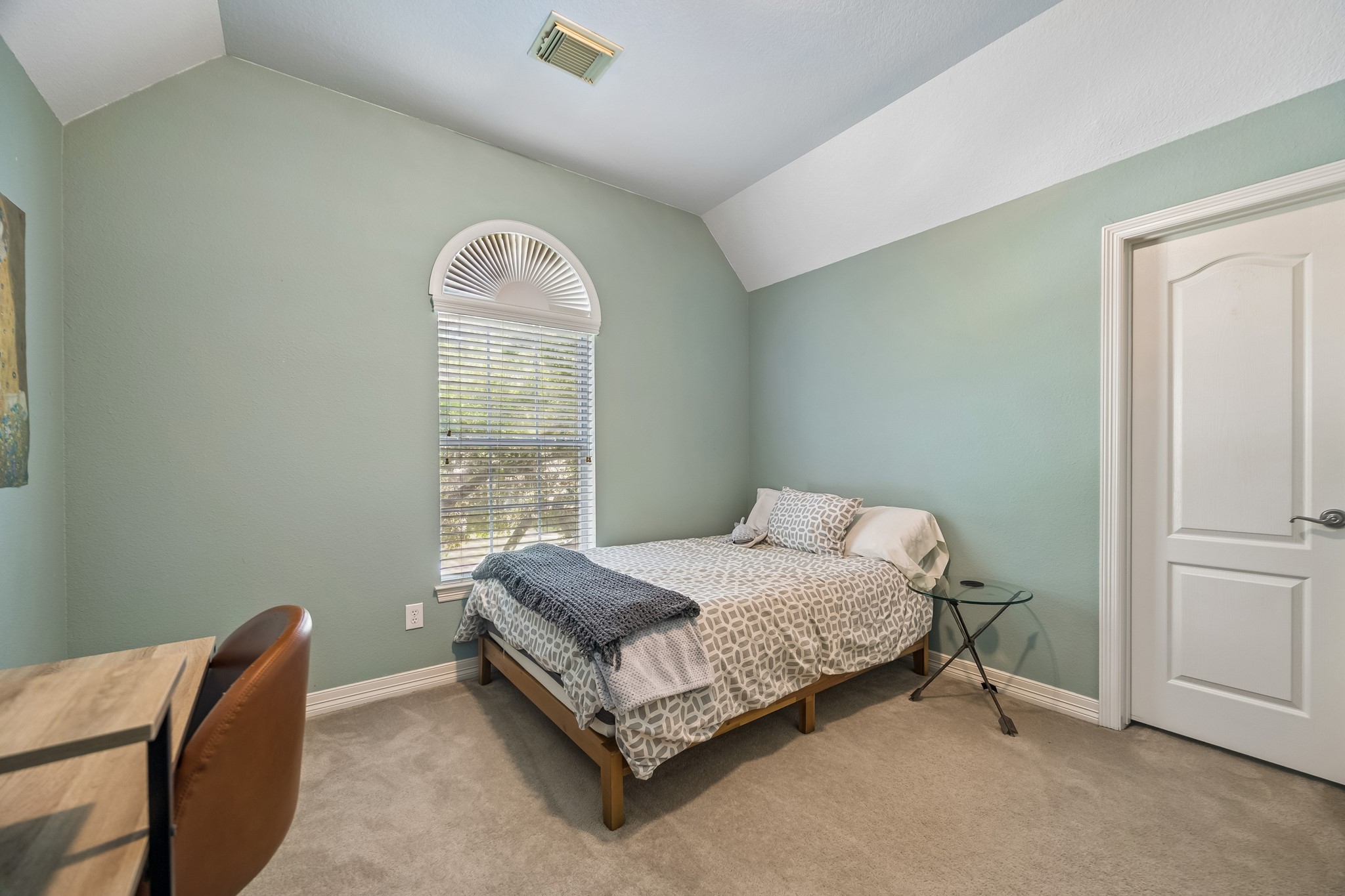 5718 Brennan Ridge Lane Katy, TX 77450 - Photo 25 of 42 SPACIOUS UPSTAIRS SECONDARY BEDROOM: Vaulted ceilings, generous proportions, and a large walk-in closet create a comfortable retreat designed to grow with changing needs.