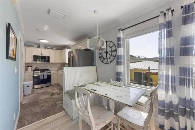 a view of kitchen with sink and refrigerator