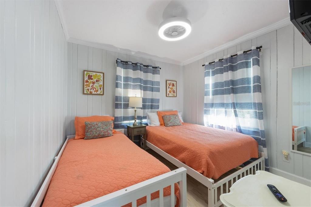 110 Oak Avenue, Unit A Anna Maria, FL 34216 - Photo 16 of 30 a bedroom with two beds and a window