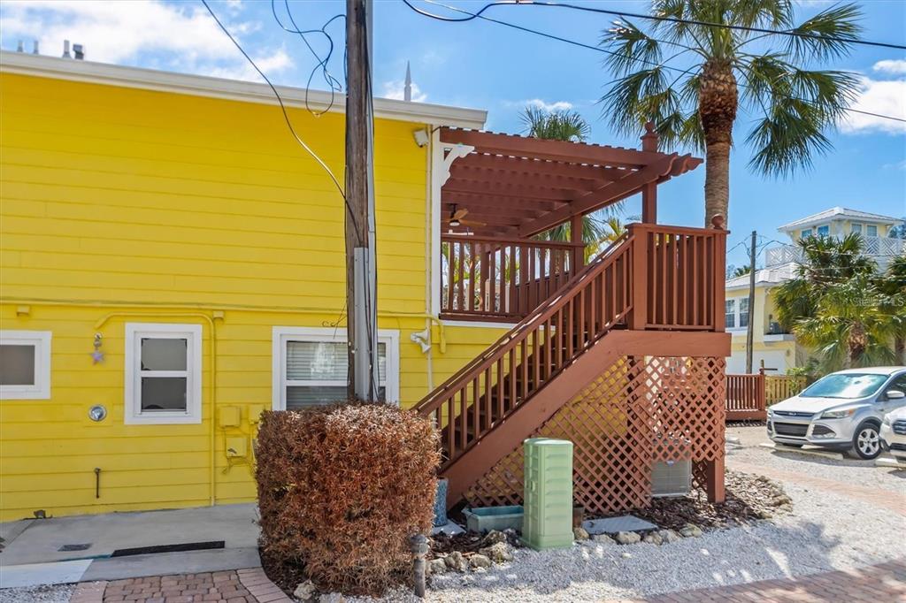 110 Oak Avenue, Unit A Anna Maria, FL 34216 - Photo 5 of 30 a view of a balcony with couches and wooden floor