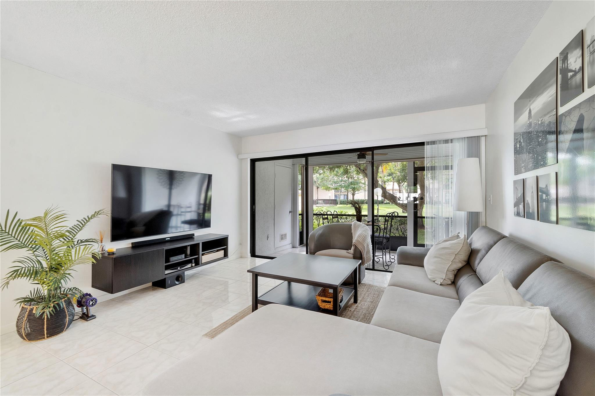 2289 Southwest 15th Street, Unit 129 Deerfield Beach, FL 33442 - Photo 12 of 41 a living room with furniture and a flat screen tv