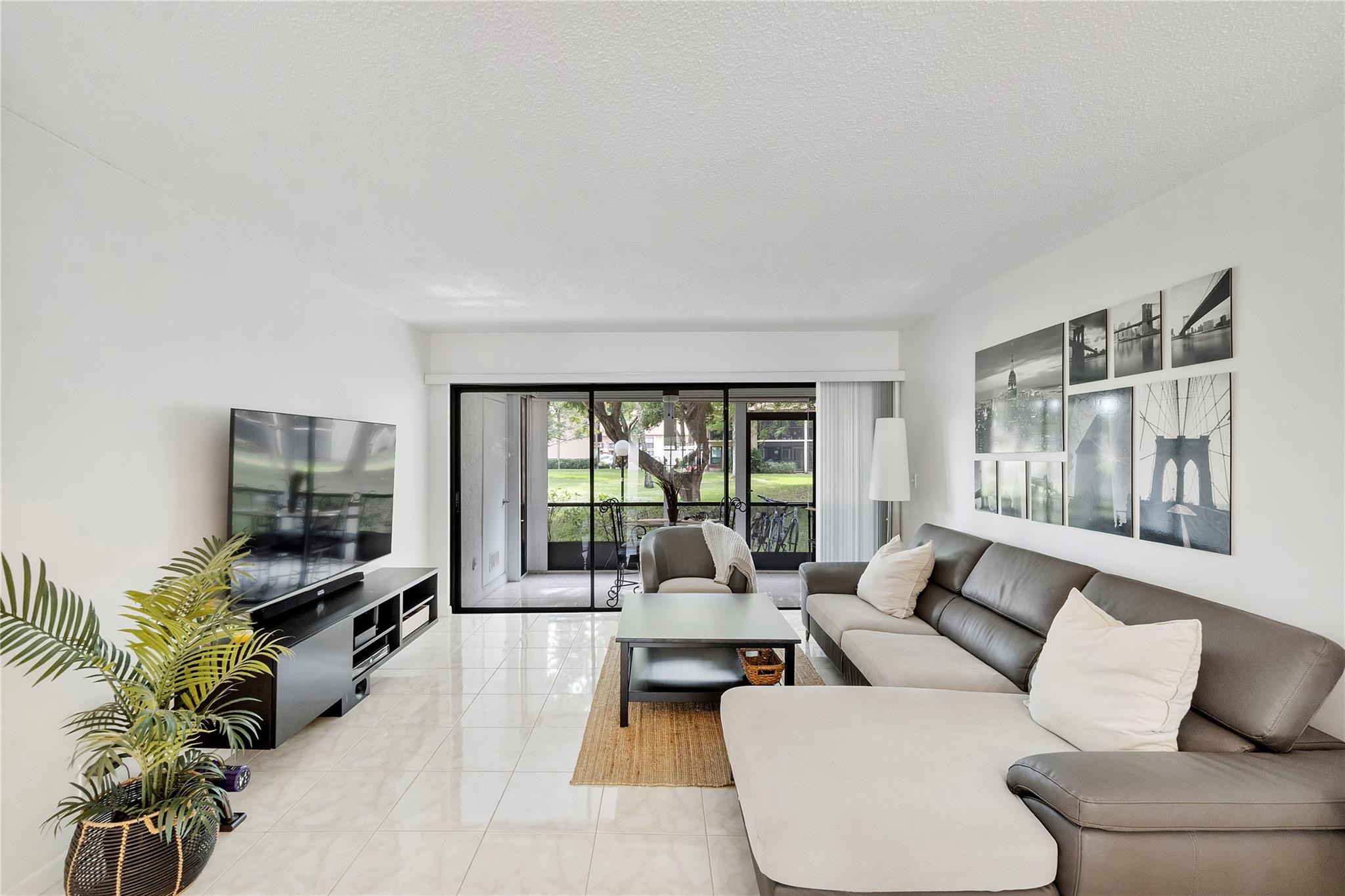 2289 Southwest 15th Street, Unit 129 Deerfield Beach, FL 33442 - Photo 13 of 41 a living room with furniture and a flat screen tv