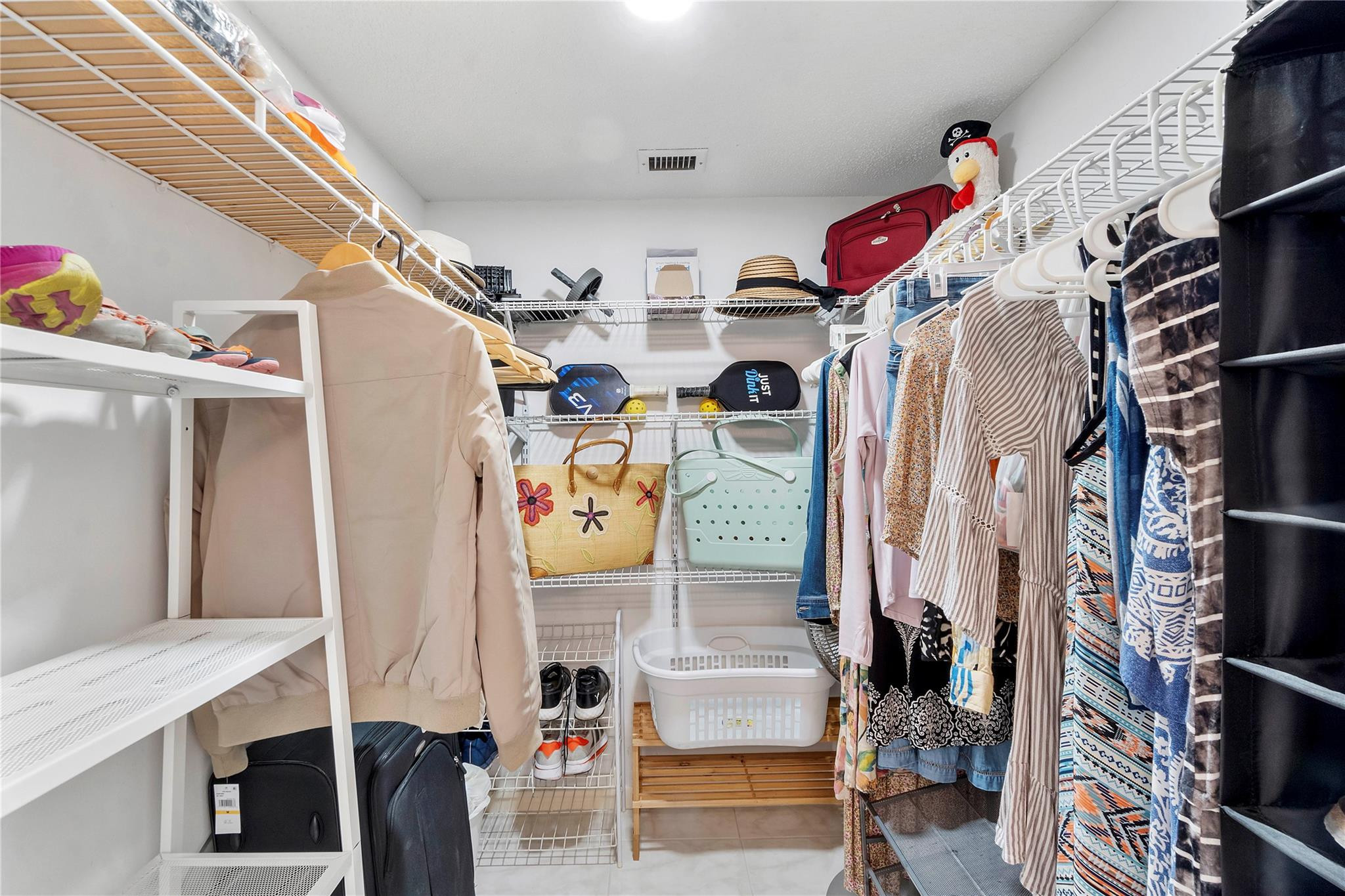 2289 Southwest 15th Street, Unit 129 Deerfield Beach, FL 33442 - Photo 17 of 41 a view of walk in closet with clothes and shoes