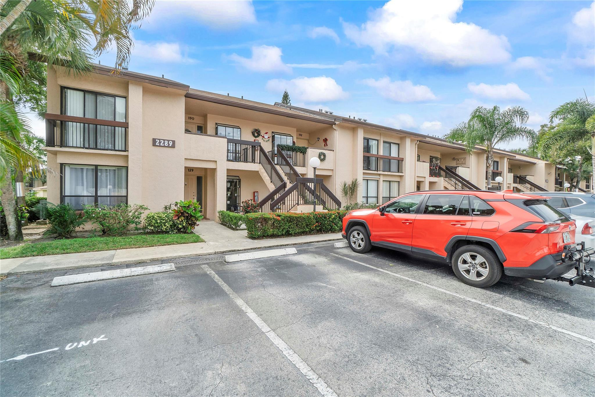 2289 Southwest 15th Street, Unit 129 Deerfield Beach, FL 33442 - Photo 33 of 41 a car parked in front of a house
