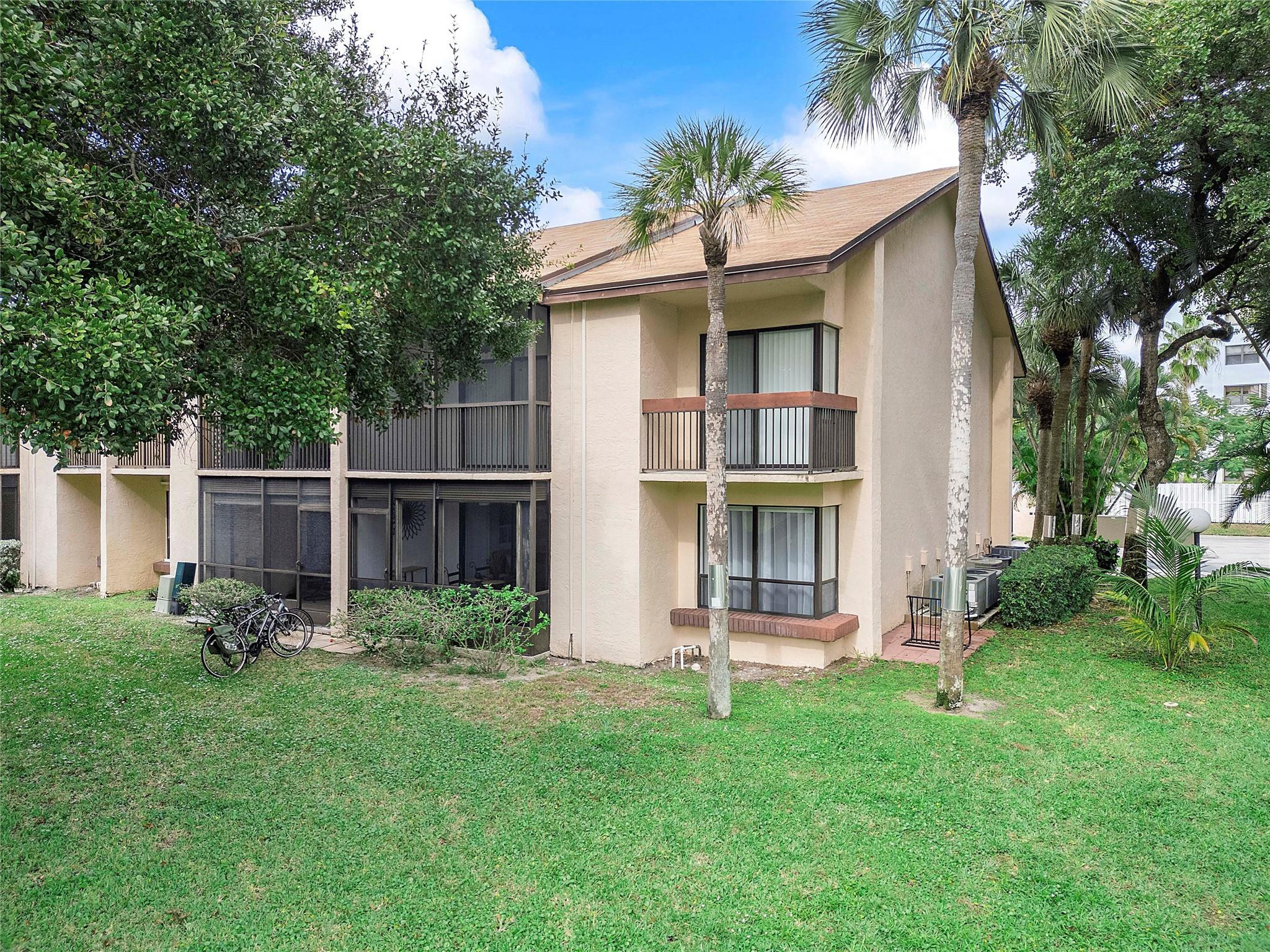 2289 Southwest 15th Street, Unit 129 Deerfield Beach, FL 33442 - Photo 34 of 41 front view of a house with a yard