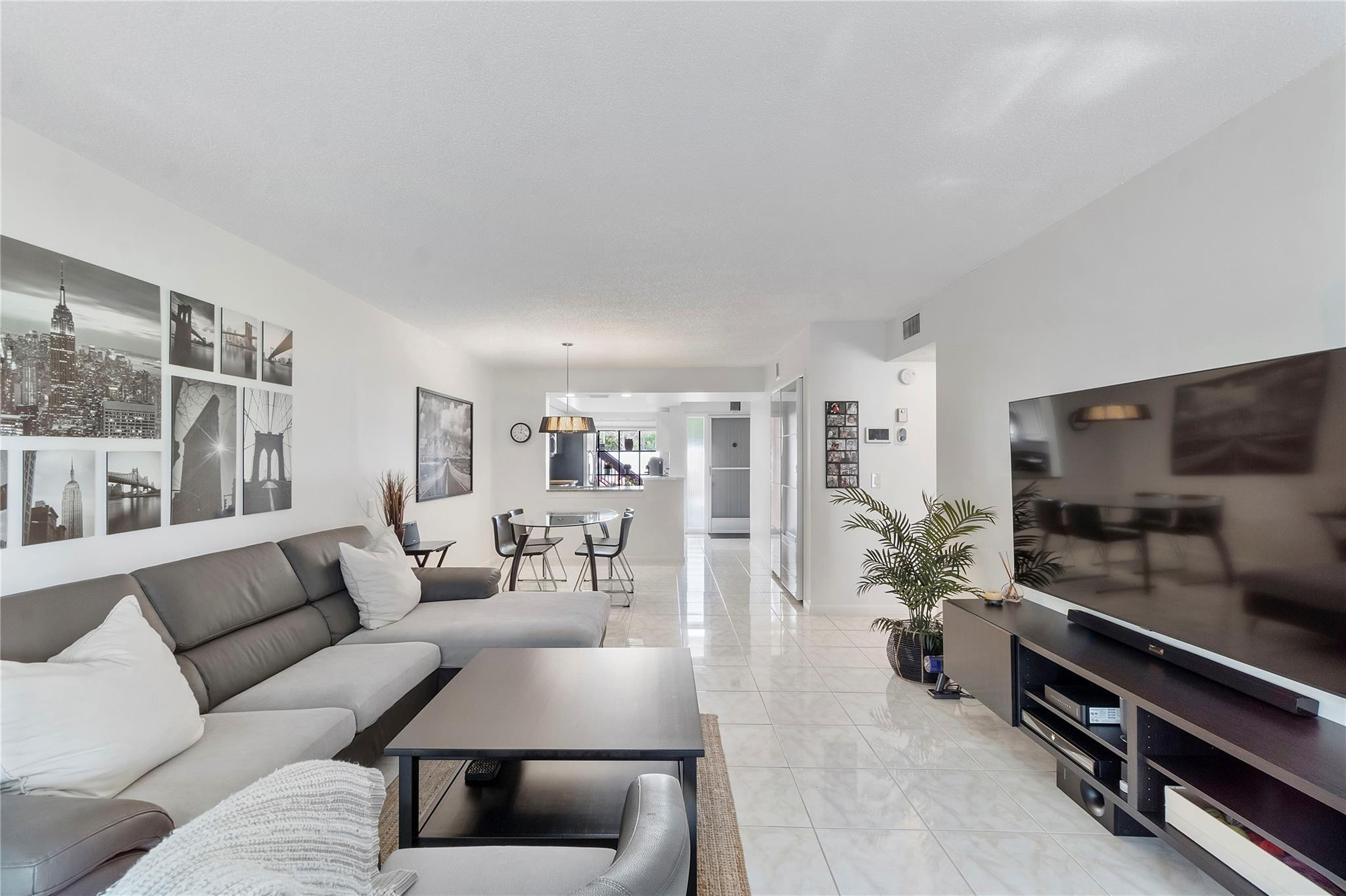 2289 Southwest 15th Street, Unit 129 Deerfield Beach, FL 33442 - Photo 8 of 41 a living room with furniture and a flat screen tv