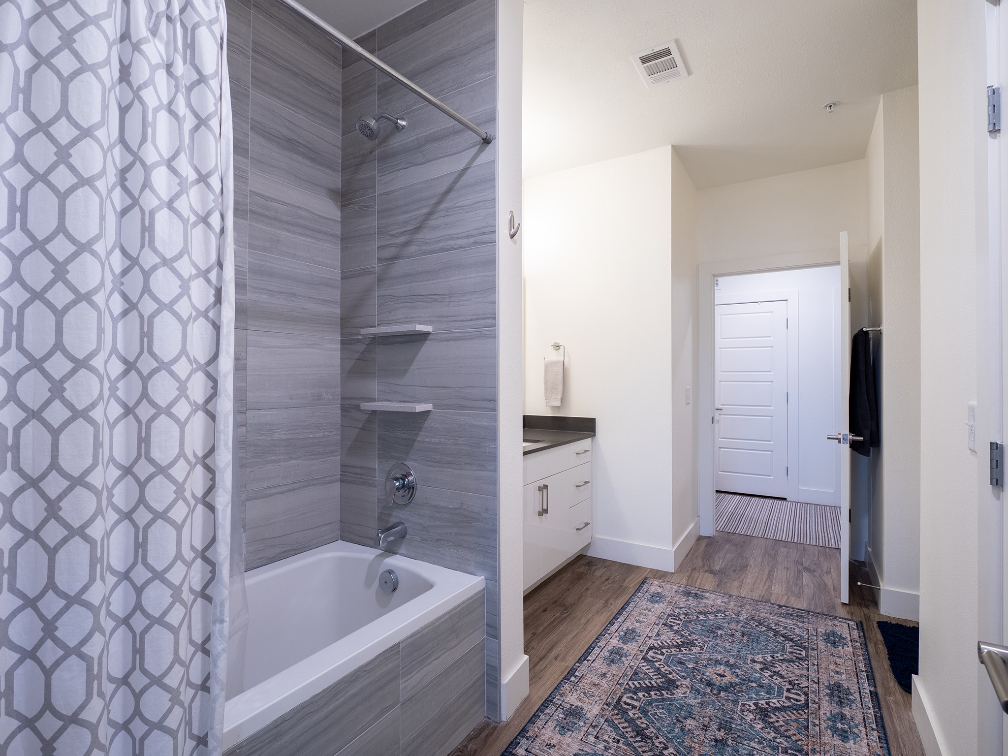 6444 Burnet Road, Unit 509 Austin, TX 78757 - Photo 18 of 32 A refined bath with sleek tiled shower and coordinating vanity offers modern comfort.