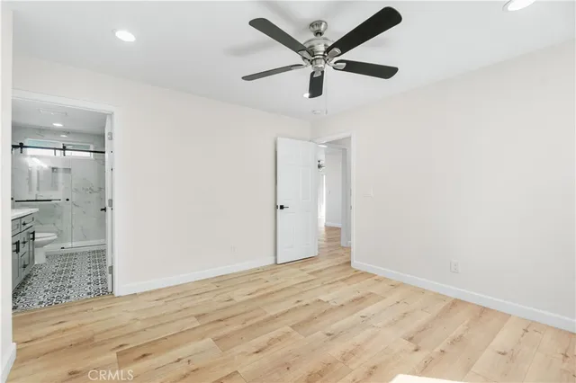 an empty room with fan and a ceiling fan