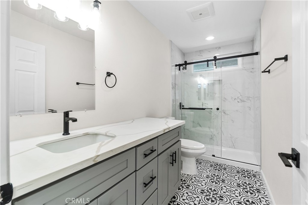 523 West 12th Street, Unit 4 San Pedro, CA 90731 - Photo 13 of 18 a bathroom with a sink toilet double vanity and shower