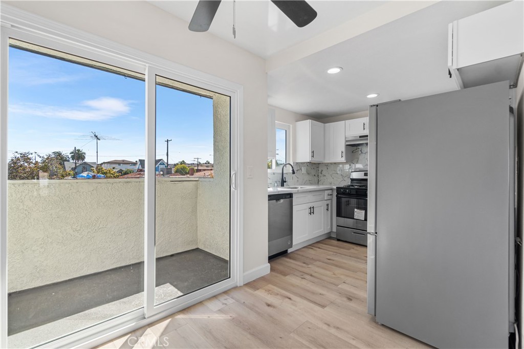 523 West 12th Street, Unit 4 San Pedro, CA 90731 - Photo 7 of 18 a kitchen with stainless steel appliances granite countertop a refrigerator a sink and a stove with wooden floor