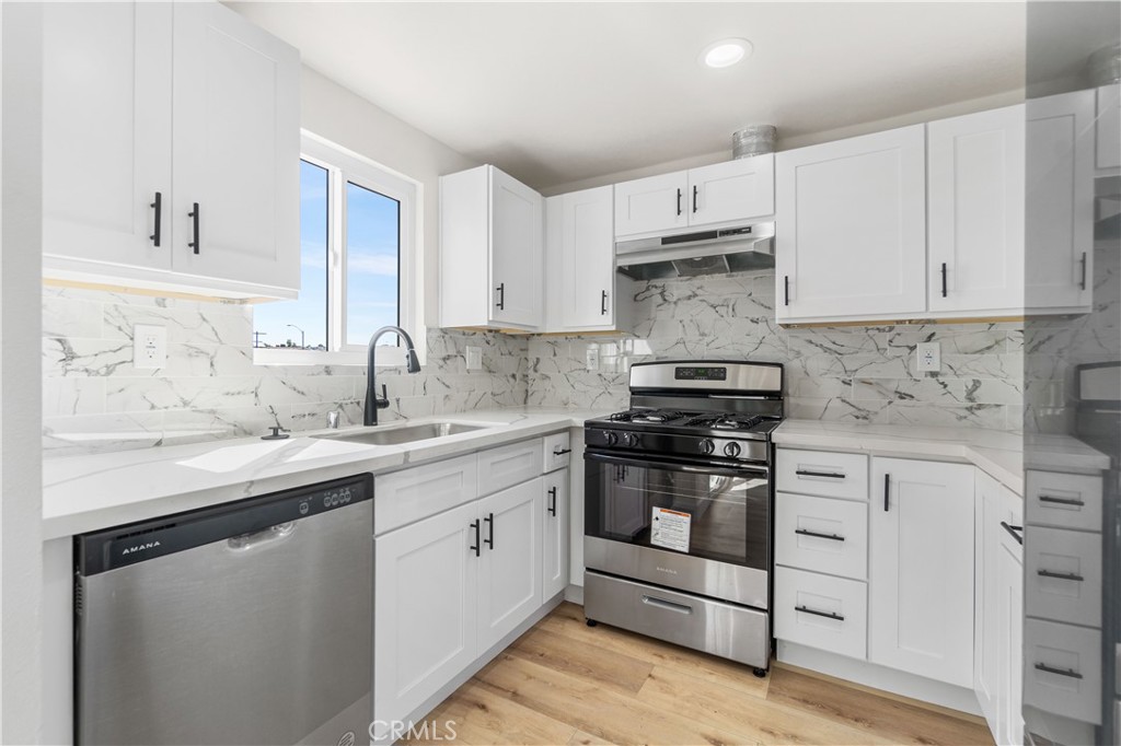 523 West 12th Street, Unit 4 San Pedro, CA 90731 - Photo 8 of 18 a kitchen with stainless steel appliances granite countertop a sink and cabinets