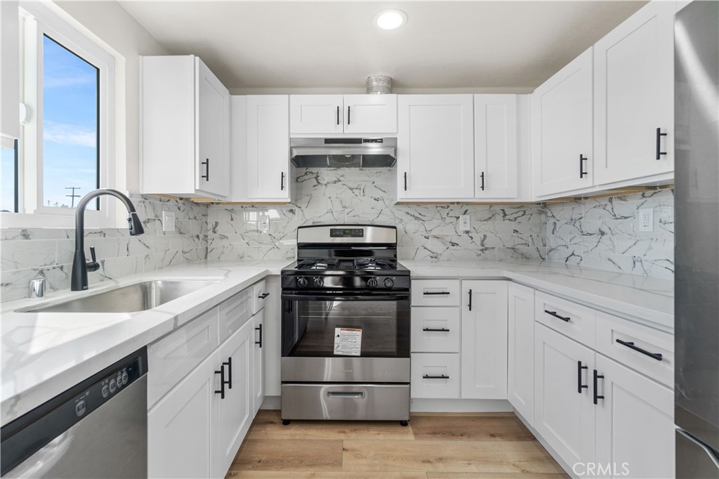 523 West 12th Street, Unit 4 San Pedro, CA 90731 - Photo 9 of 18 a kitchen with cabinets appliances a sink and a stove