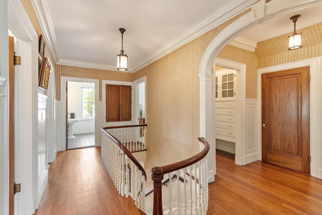 89 Lothrop Street Beverly, MA 01915 - Photo 23 of 41 a view of a hallway with wooden floor and staircase