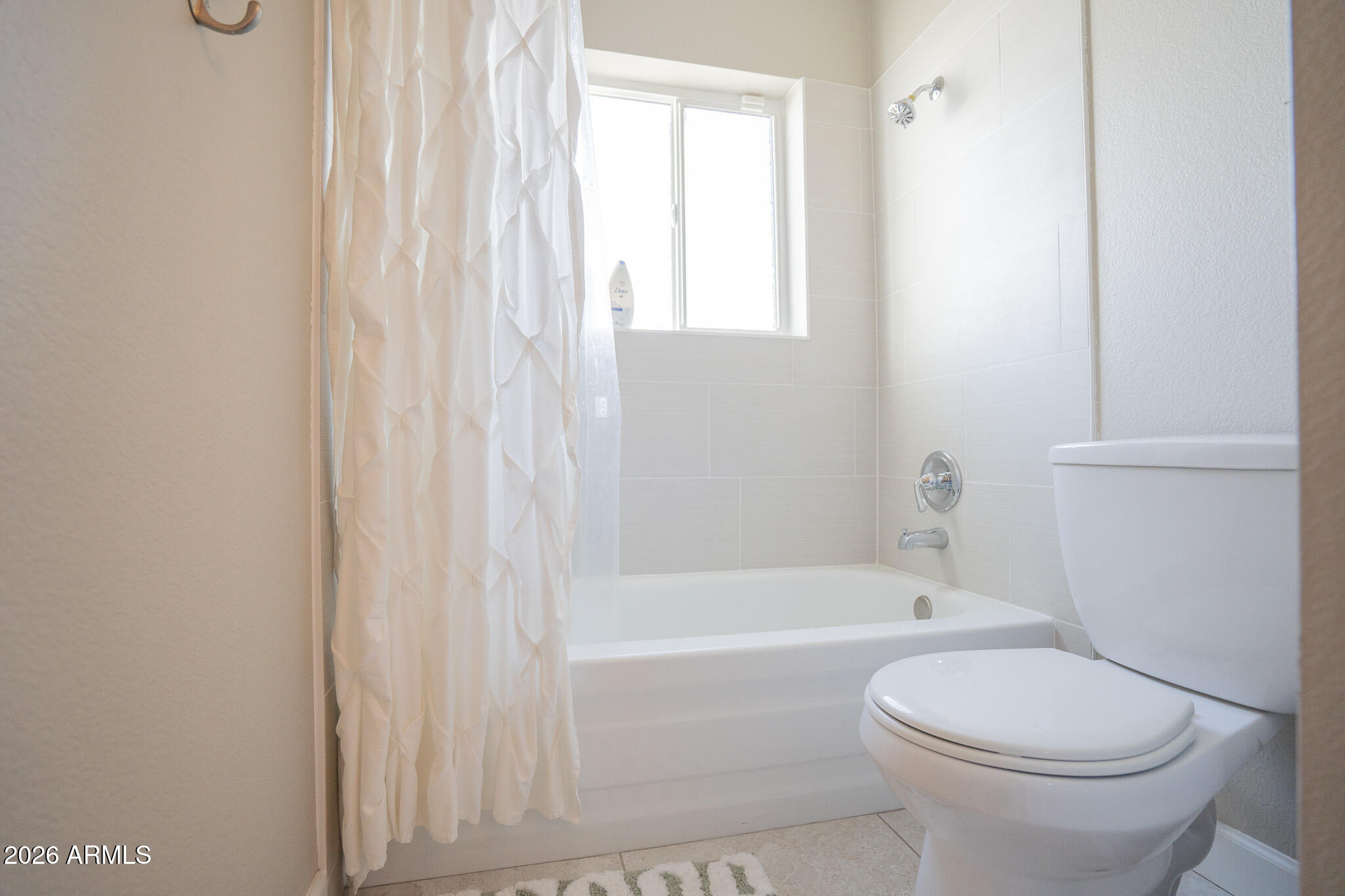 1201 East Rowlands Lane Phoenix, AZ 85022 - Photo 11 of 40 a bathroom with a toilet and a bathtub