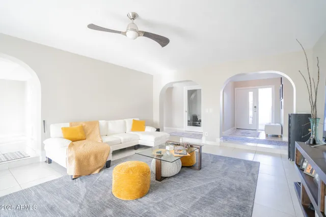 a living room with furniture and a chandelier