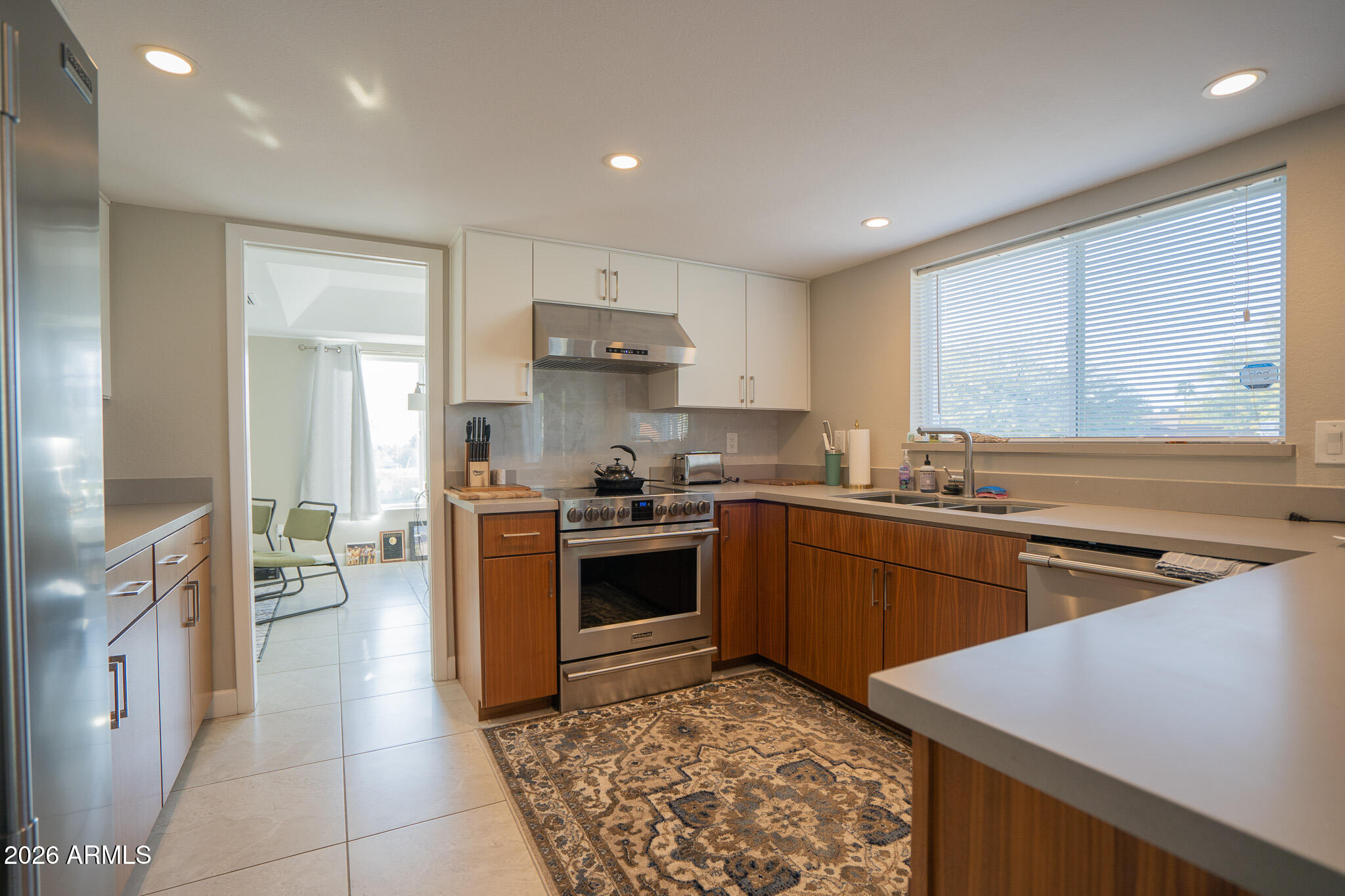 1201 East Rowlands Lane Phoenix, AZ 85022 - Photo 20 of 40 a kitchen with a stove a sink and a refrigerator
