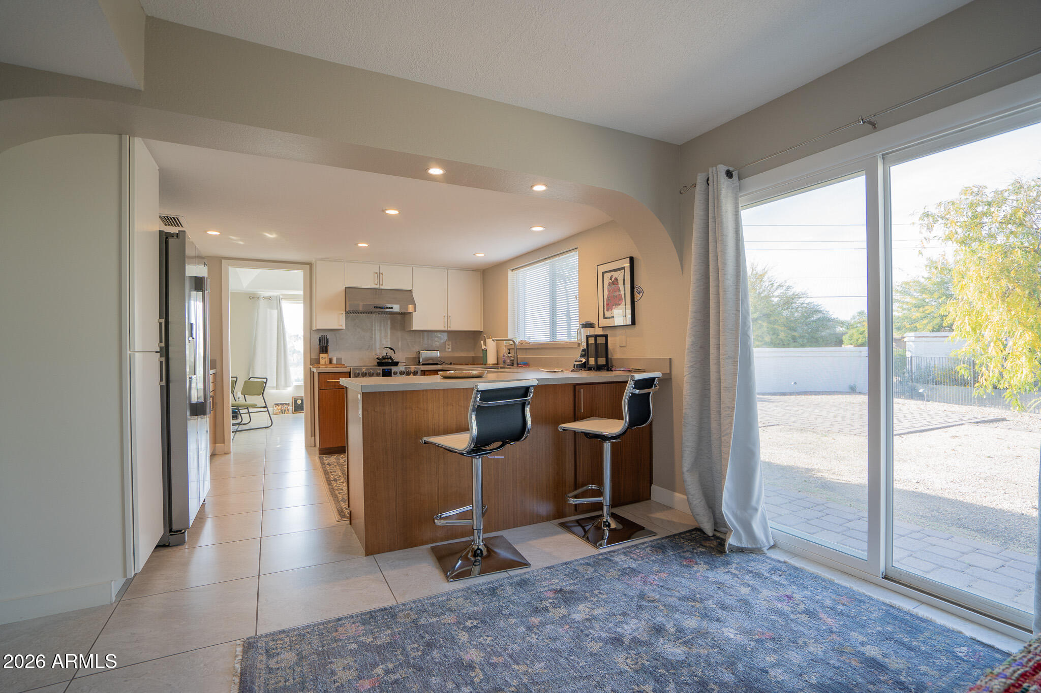 1201 East Rowlands Lane Phoenix, AZ 85022 - Photo 23 of 40 a view of a kitchen with dining table and chairs