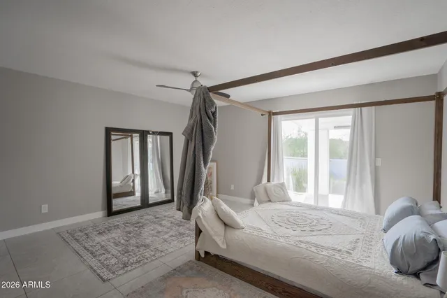 a bedroom with a bed and a window