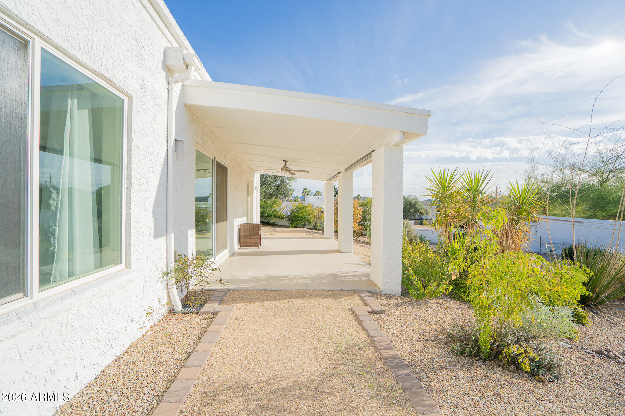 1201 East Rowlands Lane Phoenix, AZ 85022 - Photo 37 of 40 a front view of a house with a yard and potted plants