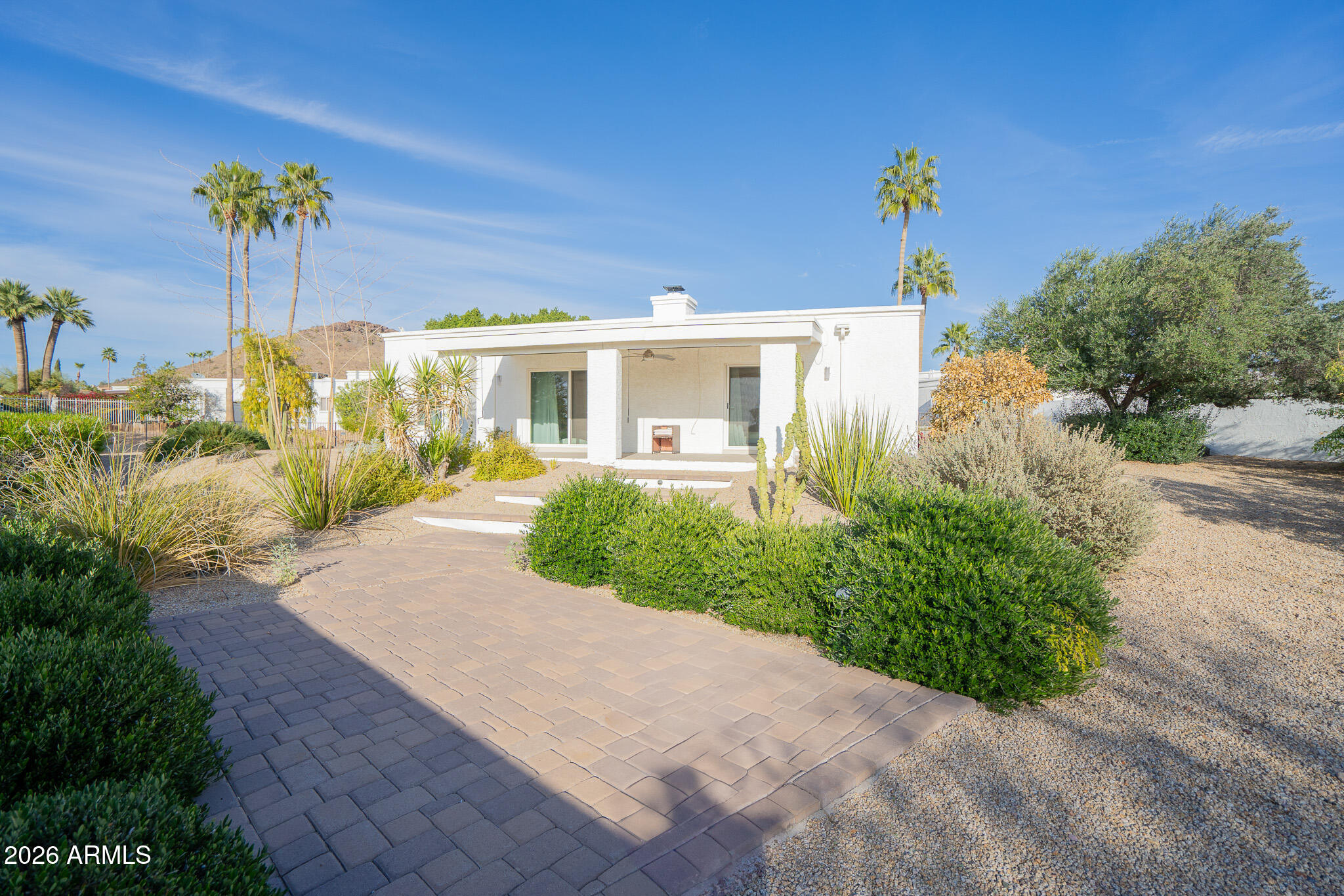 1201 East Rowlands Lane Phoenix, AZ 85022 - Photo 40 of 40 a front view of a house with a yard and potted plants