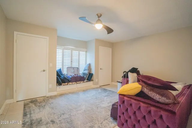 a bed room with a bed and a chair