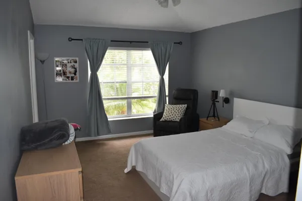 a bedroom with a bed and a window