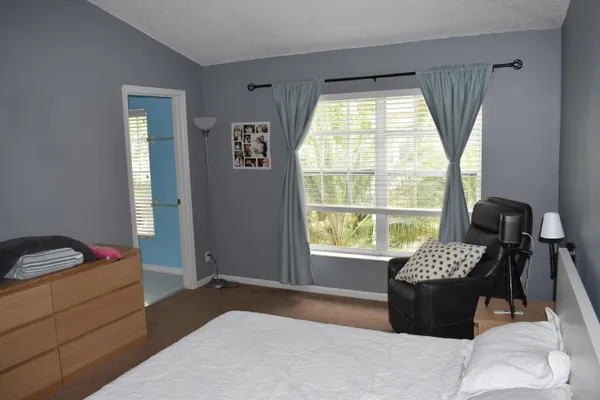 a bedroom with a bed and a window