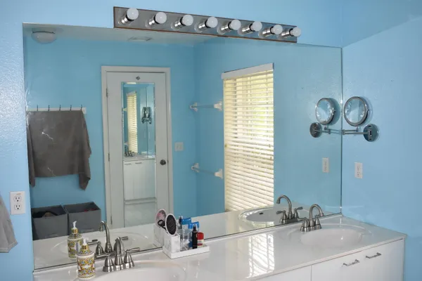 a bathroom with a double vanity sink and a mirror