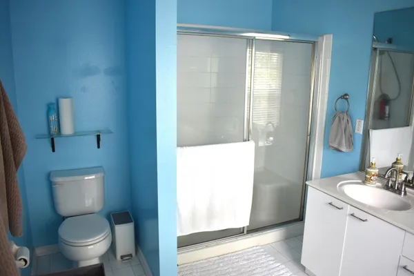 a bathroom with a toilet sink and shower