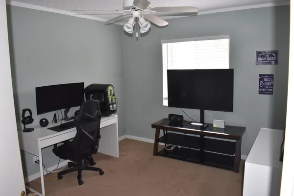 a work room with furniture and a flat screen tv