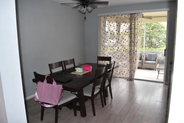 a view of a dining room with furniture and wooden floor