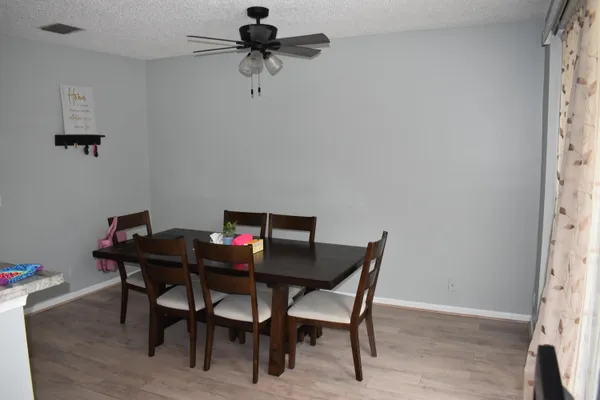 a view of a dining room with furniture and wooden floor