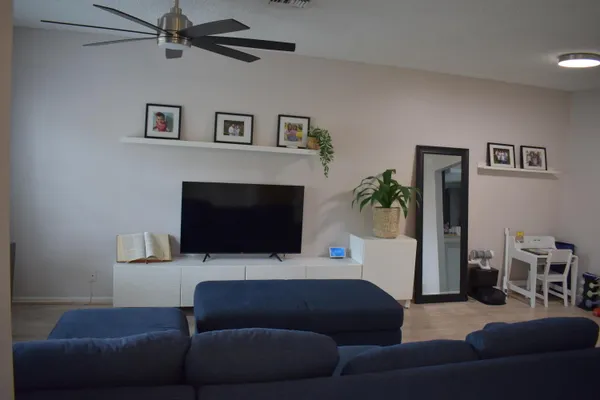 a living room with furniture and a flat screen tv
