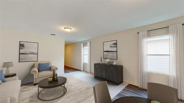 a living room with furniture and wooden floor