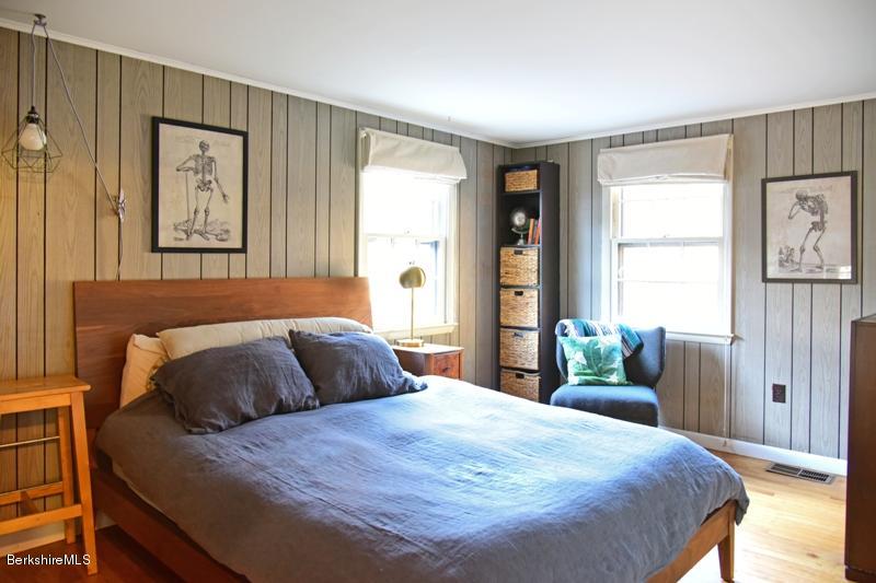 142 Polikoff Road Sheffield, MA 01222 - Photo 16 of 26 a bedroom with a bed and wooden floor