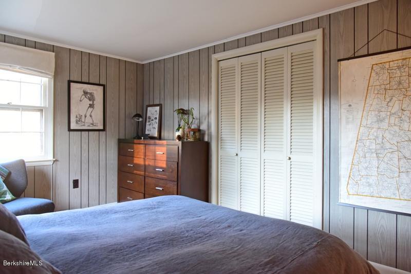 142 Polikoff Road Sheffield, MA 01222 - Photo 17 of 26 a bedroom with a bed and wooden floor