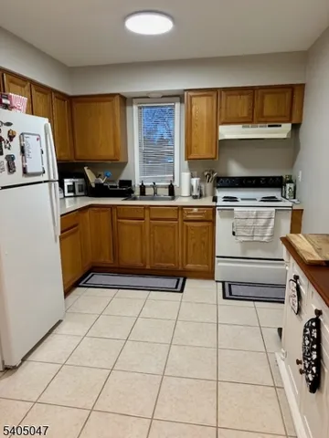 a kitchen with a stove a sink and a refrigerator