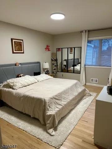 a bed sitting in a bedroom next to a window