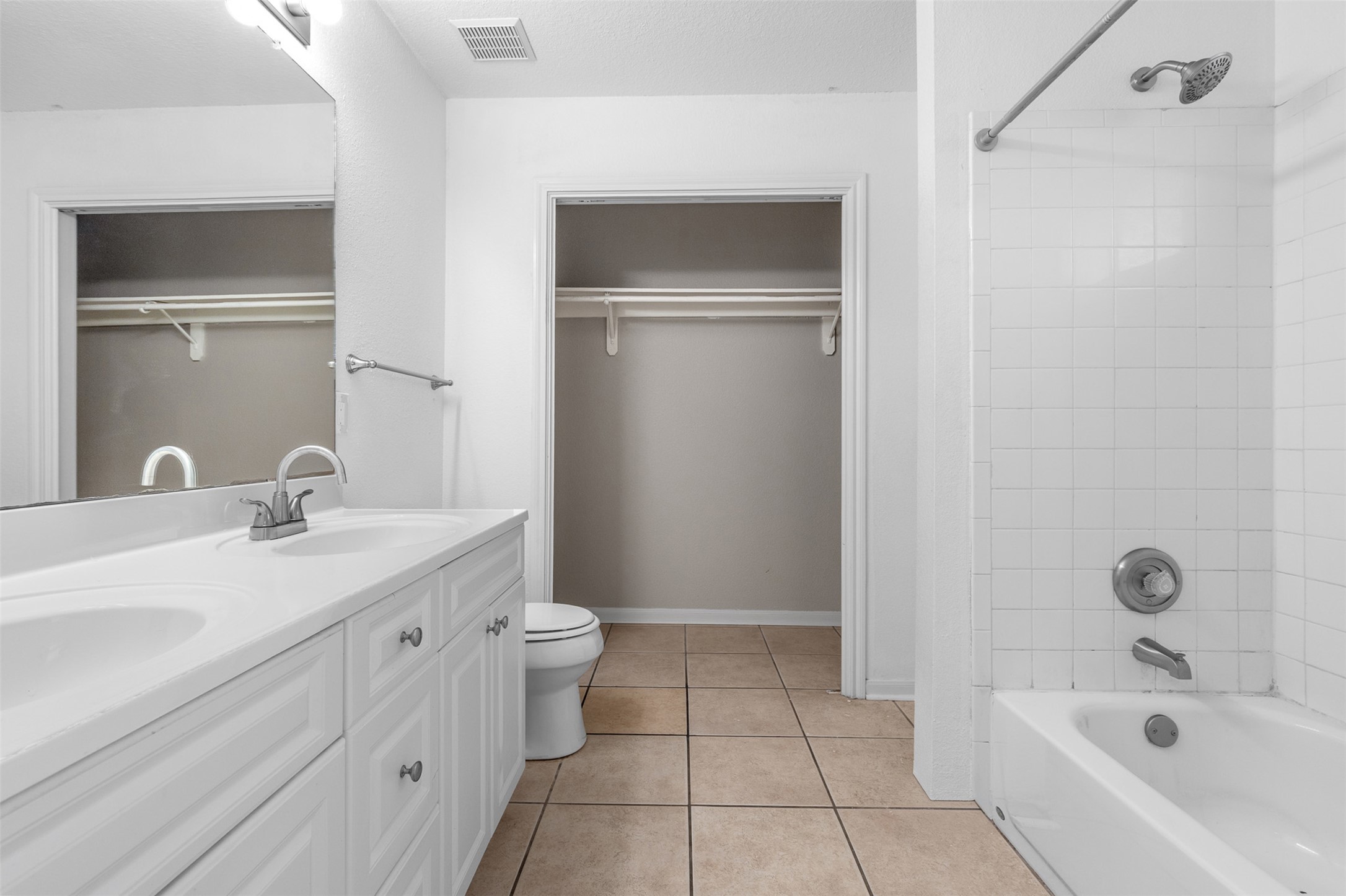 2602 Peach Tree Lane Cedar Park, TX 78613 - Photo 11 of 14 Primary bathroom with shower / tub combination, double vanity, light tile patterned floors, and a walk-in closet.