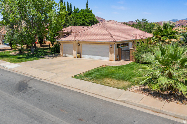 3034 Swiss Drive Santa Clara, UT 84765 - Photo 56 of 59 Single-story residence featuring a tile roof, an attached two-car garage, and a concrete driveway