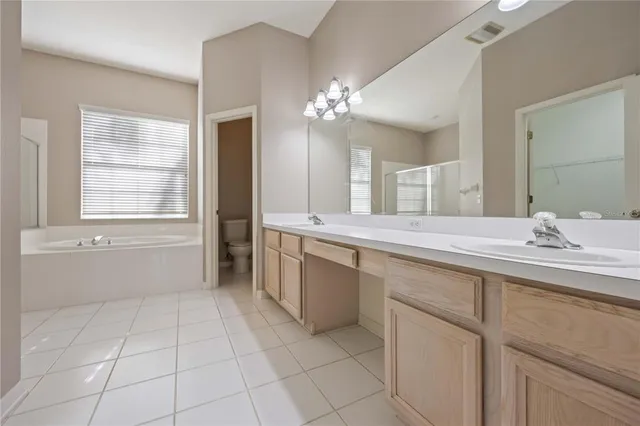 a white bath tub sitting next to a toilet